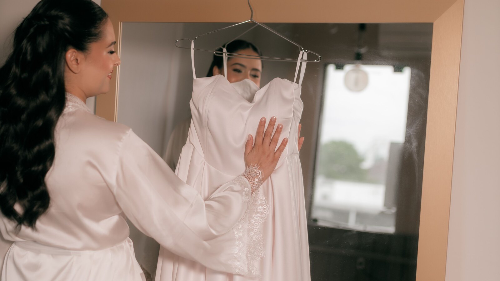 A bride and a consultant looking at gowns together